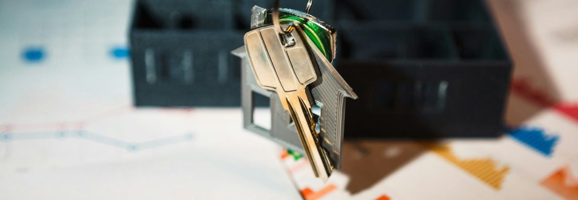 A house shaped keychain hanging from a key chain