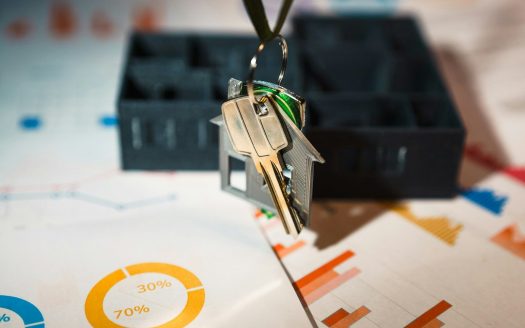 A house shaped keychain hanging from a key chain