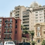 A group of buildings with cars parked in front of them