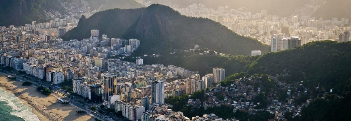 an aerial view of a city with mountains in the background