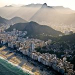 an aerial view of a city with mountains in the background