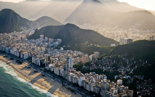 an aerial view of a city with mountains in the background