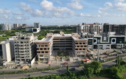 white concrete building near green trees under white clouds during daytime
