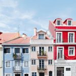Colorful residential buildings with tiled facades on a sloped street in Lisbon